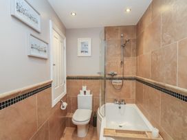 A bathroom with a shower, bathtub, and toilet at Jolly Roger in Whitby