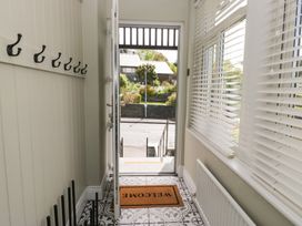 A hallway with hooks and a welcome mat at 5 Thornbarrow Road in 