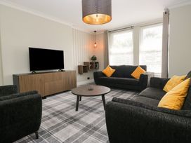 A living room with a television and a coffee table at 5 Thornbarrow Road