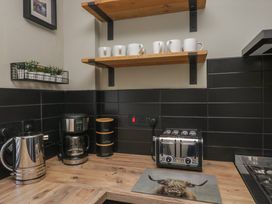 A kitchen area with a kettle, coffee maker, and toaster at 5 Thornbarrow Road