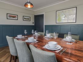 A dining room with a wooden table set for a meal at 5 Thornbarrow Road 
