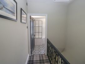 A hallway with a door leading to a bathroom at 5 Thornbarrow Road