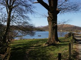 A view of a lake with a tree and a road at 5 Thornbarrow Road 