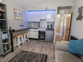 A kitchen with appliances and seating at Estuary Escape in Porthmadog