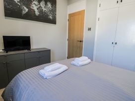 A bedroom with a bed and towels on it at Estuary Escape in Porthmadog