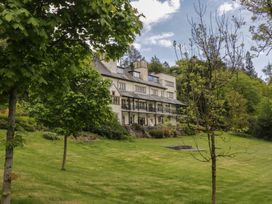 A house with a balcony and trees in the garden at Deer Wood At Applethwaite Hall Windermere
