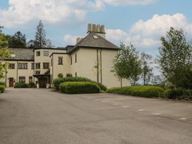 A building with a parking lot and trees at Deer Wood At Applethwaite Hall Windermere