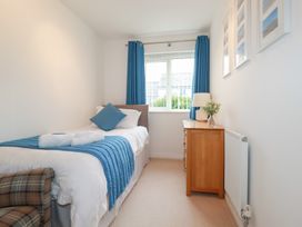 A bedroom with a bed and bedside table at Blissful Ocean Breeze in Perranporth