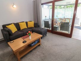 A living room with a sofa and a coffee table at Lake View, Swanpool, Nr Falmouth