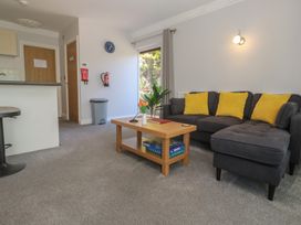 A living room with a table and sofa at Lake View, Swanpool, Nr Falmouth