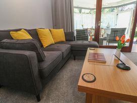 A living room with a sofa and coffee table at Lake View in Swanpool, Nr Falmouth