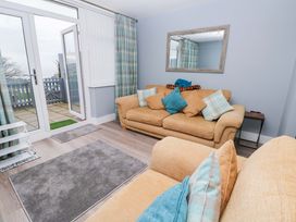 A living room with a sofa and cushions at 3 Devon Court in Pembroke