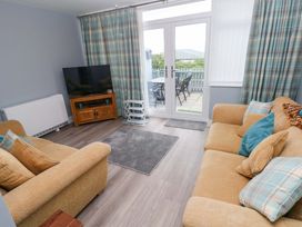 A living room with a television and sofa at 3 Devon Court in Pembroke
