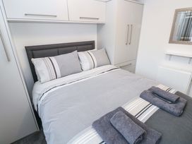 A bedroom with a bed and storage at 3 Devon Court Pembroke