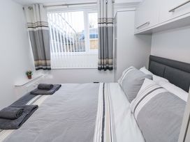 A bedroom with a bed and window at 3 Devon Court in Pembroke