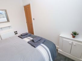 A bedroom with a bed and towels at 3 Devon Court in Pembroke