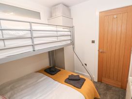 A bedroom with a bunk bed and double bed at 3 Devon Court in Pembroke