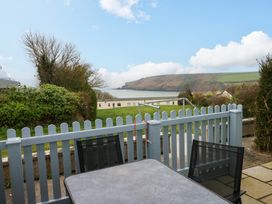 A patio with a table and chairs overlooking the sea at 3 Devon Court Pembroke