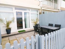 An outdoor area with a table and chairs at 3 Devon Court in Pembroke