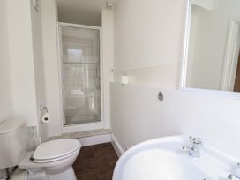 A bathroom with a toilet sink and shower at Serenity House The Retreat in Llangammarch Wells near Llanwrtyd Wells