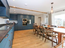 A kitchen featuring cabinets and a dining table at Yr Hen Felin Dyffryn Ardudwy