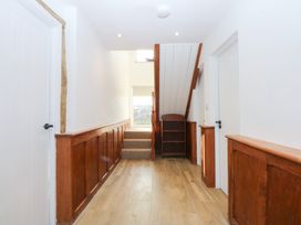 A hallway with a staircase and doors at Yr Hen Felin in Dyffryn Ardudwy