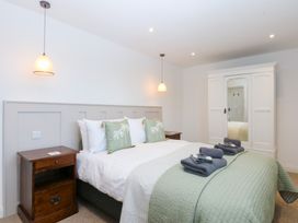 A bedroom with a bed and wardrobe at Yr Hen Felin Dyffryn Ardudwy