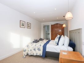 A bedroom with a bed and nightstand at Yr Hen Felin in Dyffryn Ardudwy