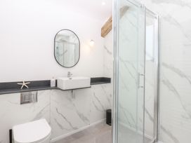 A bathroom with a sink and shower at Yr Hen Felin Dyffryn Ardudwy