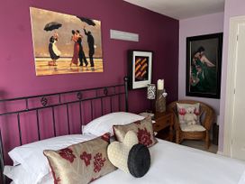 A bedroom with a bed and decorative pillows at 20 Keay Heights in St Austell