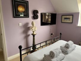 A bedroom with a bed and television at 20 Keay Heights St Austell