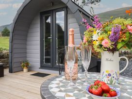 An outdoor area with drinks and flowers at Caban Tirion in Dinas Mawddwy near Dolgellau