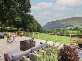 An outdoor space with seating and views of mountains at Caban Tirion in Dinas Mawddwy near Dolgellau