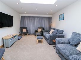 A living room with a television and seating area at The Swanage Rail Lookout in Swanage