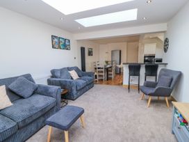A living room with sofas and a dining area at The Swanage Rail Lookout in Swanage