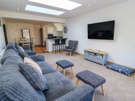 A living room with a television and sofa at The Swanage Rail Lookout in Swanage