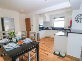 A kitchen with a dining table set for breakfast at The Swanage Rail Lookout in Swanage
