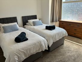 A bedroom with two beds and a dresser at The Swanage Rail Lookout in Swanage