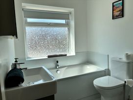 A bathroom with a bath tub and sink at The Swanage Rail Lookout in Swanage