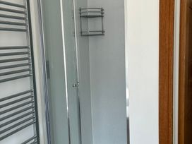 A bathroom with a shower and a towel rail at The Swanage Rail Lookout in Swanage