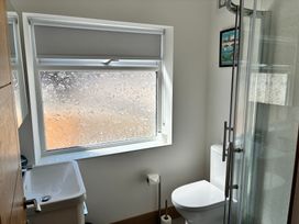 A bathroom with a toilet, sink, and shower at The Swanage Rail Lookout in Swanage