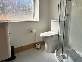 A bathroom with a sink, toilet and shower at The Swanage Rail Lookout in Swanage