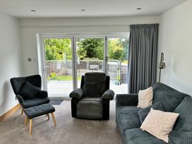 A living room with a sofa and armchair at The Swanage Rail Lookout in Swanage