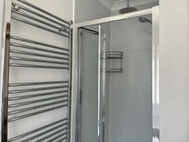 A bathroom with a shower and towel warmer at The Swanage Rail Lookout in Swanage