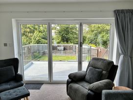 A living room with sliding doors leading to a deck at The Swanage Rail Lookout in Swanage