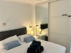 A bedroom with a bed and bedside table at The Swanage Rail Lookout in Swanage