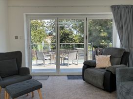 A living room with sliding doors leading to a deck at The Swanage Rail Lookout in Swanage