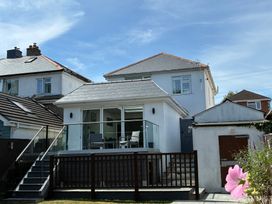 An outdoor view of a house with a balcony and garden at The Swanage Rail Lookout in Swanage