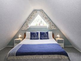 A bedroom with a bed and bedside tables at Chalet 58 - The Beach House Kingsdown