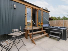 An outdoor area with steps and a hot tub at Dam View Shepherds Hut Upper Bwlch near Rhayader